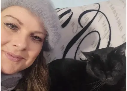 “Jillian Evelyn with her black cat Felix, featured on her True Sidereal Human Design About page.