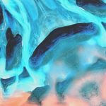 Stunning abstract art featuring dynamic blue and coral colors with fluid patterns.